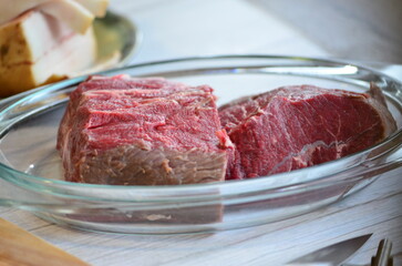 raw meat on a white background in a glass container, close-up