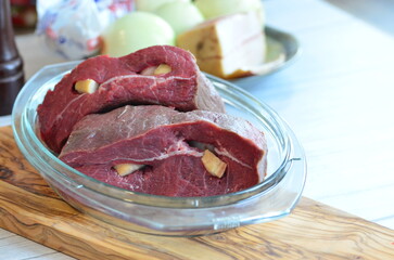 raw meat on a white background in a glass container, close-up