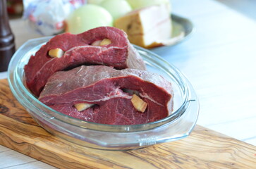 raw meat on a white background in a glass container, close-up
