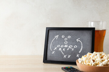 Black board with game strategy and a bowl of popcorn