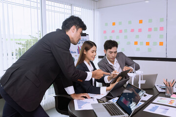 Team of Asian business people talking and planning working together in modern office.