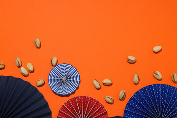 Pistachios with umbrellas on a light background