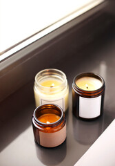 Lighting candles on windowsill in home interriors close up