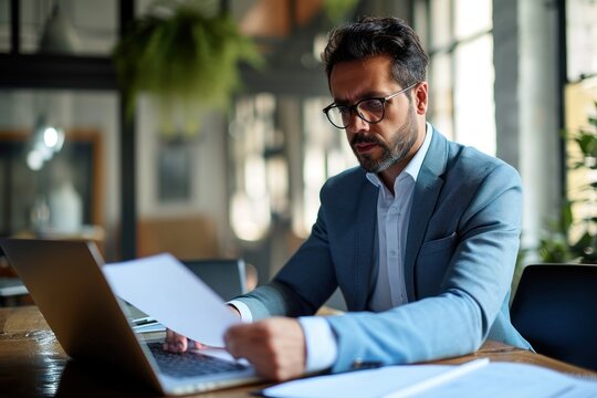 Young busy latin professional business man checking document working at laptop computer in office. Serious businessman accountant expert reading legal, Generative AI