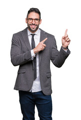 Young handsome business man over isolated background smiling and looking at the camera pointing with two hands and fingers to the side.