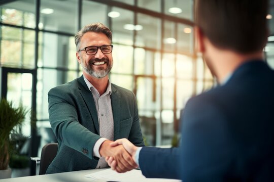 Smiling middle aged business man handshaking partner making partnership collaboration agreement at office meeting, hr manager and new worker shake hands recruiting at job interview. Generative AI