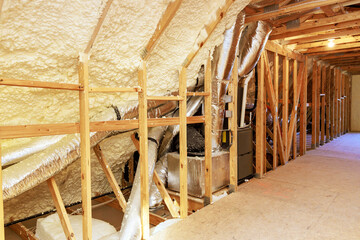 New house is insulated with thermal foam under roof when it is being constructed - obrazy, fototapety, plakaty
