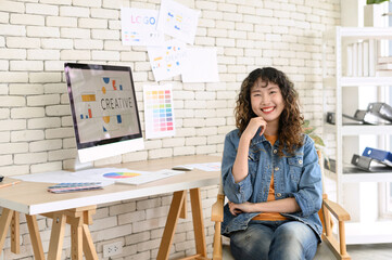 Portrait of cheerful female graphic designers in office. Creative people smiling at the camera...