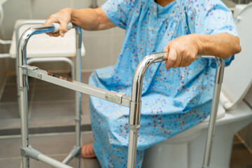 Asian elderly woman patient use toilet bathroom handle security in nursing hospital, healthy strong...