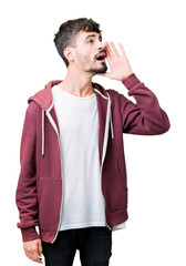 Young handsome man over isolated background shouting and screaming loud to side with hand on mouth. Communication concept.