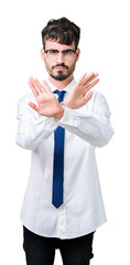 Young handsome business man wearing glasses over isolated background Rejection expression crossing arms and palms doing negative sign, angry face