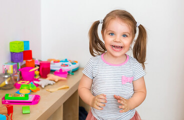 Delighted child laughing at home