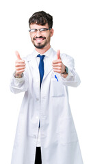 Young professional scientist man wearing white coat over isolated background approving doing positive gesture with hand, thumbs up smiling and happy for success. Looking at the camera, winner gesture.