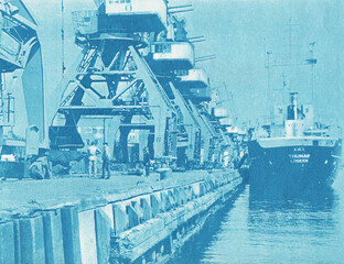 Old photo of cargo ship in port.
