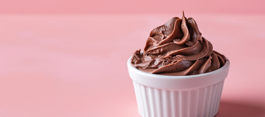 Chocolate Mousse Delight. Velvety chocolate mousse garnished with chocolate shavings and a mint leaf on pink kitchen background with copy space.