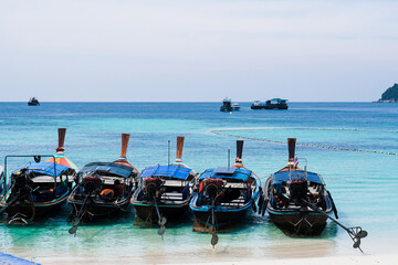 Obraz premium Longtail Boat on Beach at Koh Lipe island in Thailand. Summer colorful seascape with boats and tropical beach. Beautiful paradise in sandy seaside. Peaceful andaman sea.