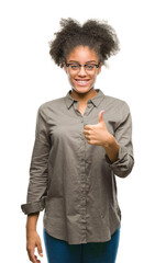 Young afro american woman wearing glasses over isolated background doing happy thumbs up gesture with hand. Approving expression looking at the camera with showing success.