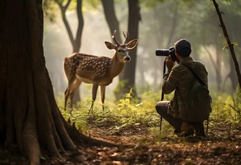 Deurstickers Toilet Photographer takes pictures of deer in forest or safari.