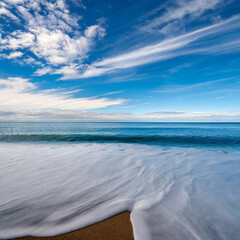 Minimalist seascape, white wave and blue sky with fluffy clouds