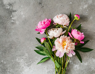Pink peony flowers bouquet on gray concrete background. Flat lay. Top view. Womens day, Valentines day, Wedding, holiday or anniversary card with copy space