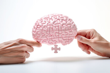 Hands holding a jigsaw puzzle model of a brain, symbolizing the intersection of medicine, neurology, and healthcare.