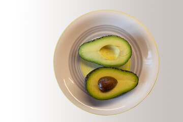 nice ripe avocado on background.avocado cut in half.avocado halves.healthy food.diet.superfood.breakfast