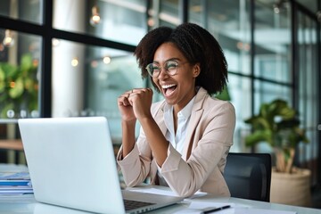 Excited successful young African American business woman winner executive looking at laptop computer celebrating financial goals achievement, happy about good professional work, Generative AI