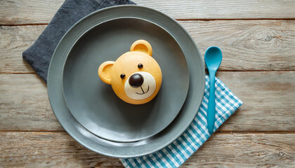 Cute children's plates and dishes shape of a bear. Creative serving for baby. Concept of kids menu, nutrition and feeding.