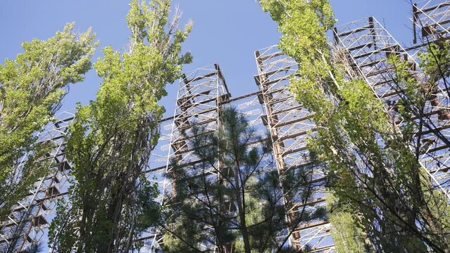 View though trees of Duga horizon radar system in the Chernobyl Exclusion Zone, Ukraine. High quality 4k footage