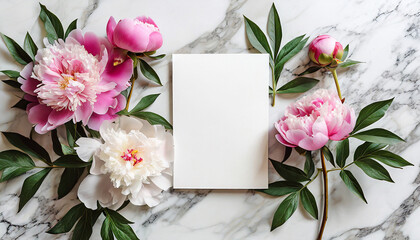 Greeting, invitation blank card with pink peony flowers on white marble background, copy space. Mock up. Flat lay. Top view. Romantic wedding holiday celebration concept