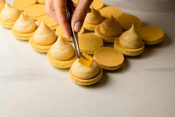Close-up photo of halves of macarons with cream, which t decorated with jellies