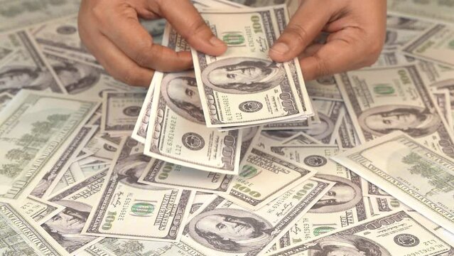 Female hand counting american hundred dollar banknotes