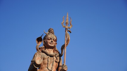statue of god shiv holding trishul closeup shot