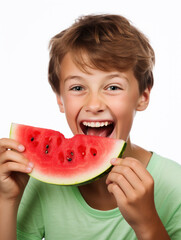 Cute little boy is eating watermelon in the studio over white background