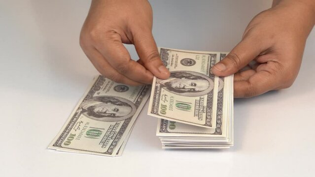 Women counting american hundred dollar on white background
