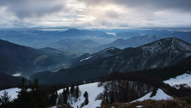 Mountainous hilly landscape in winter, Cloudy windy weather, fast movement of clouds ,timelapse. 
