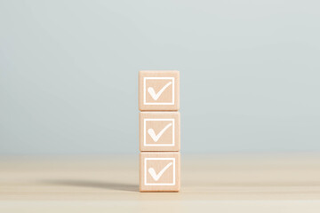 Wooden blocks display checkmarks to summarize task details and compile lists, votes, and to-do lists. Checklists, task lists, lists, and summaries Select document checklists and online quality assessm