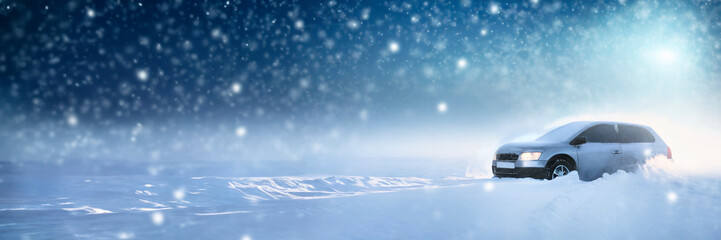 Fototapeta na wymiar Car driving on snowy road in winter, panoramic banner.