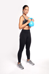 an asian woman is working out with kettlebell wearing the sport exercise suit with white background,