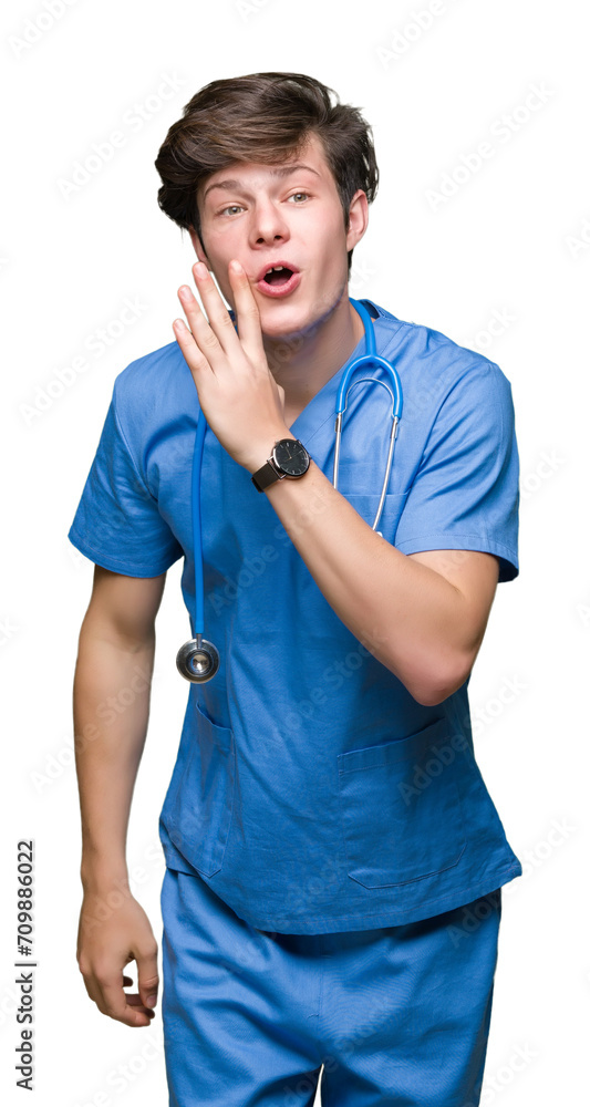Wall mural Young doctor wearing medical uniform over isolated background hand on mouth telling secret rumor, whispering malicious talk conversation - Wall murals