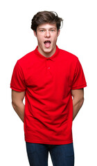 Young handsome man wearing red t-shirt over isolated background afraid and shocked with surprise expression, fear and excited face.