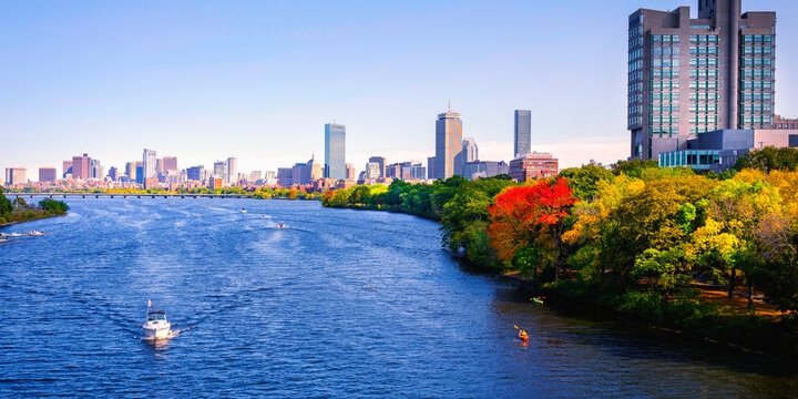 Vibrant Boston City Skyline Panorama with Skyscrapers, Curving Blue Charles River, Colorful Autumn Foliage, and Kayakers in Massachusetts, USA, a tranquil metropolitan lifestyle photo