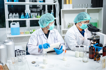 A Scientists or nutritionists are working on a sample of milk in biotechnology laboratory, genetic and bacteria research, dairy product quality control, protein, glucose and lactose percentage test. - obrazy, fototapety, plakaty