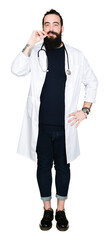 Fototapeta premium Doctor with long hair wearing medical coat and stethoscope mouth and lips shut as zip with fingers. Secret and silent, taboo talking