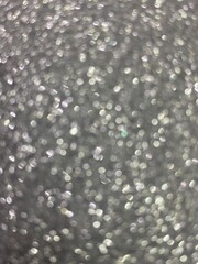 Abstract silver glitter sparkle defocused blur bokeh light background