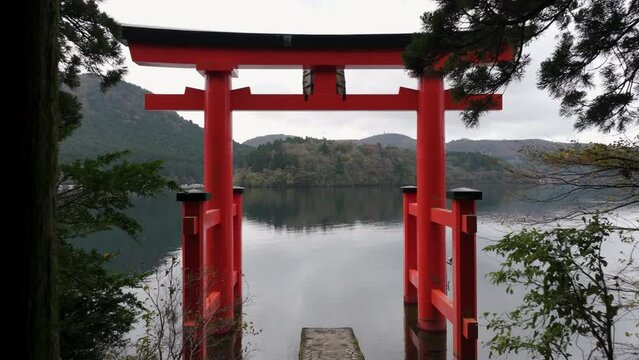 Hakone, Japan, flying through iconic torii gate on Lake Ashi. Hakone Shrine in Kanagawa Prefecture is one of the most famous shinto shrines in the area.	
