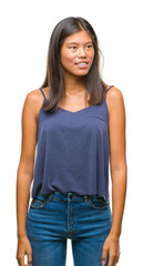 Obraz premium Young asian woman over isolated background looking away to side with smile on face, natural expression. Laughing confident.