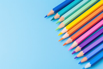 colourful pencils on a blue  background