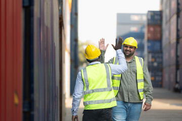 Both of workers in a container storage yard greeting each other during breaks in front of container...