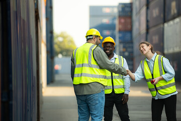Group of workers in a container storage yard greeting each other during breaks in front of...